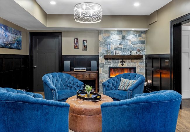 Finished basement large sitting area with fireplace and updated wall finishes (JM Construction)