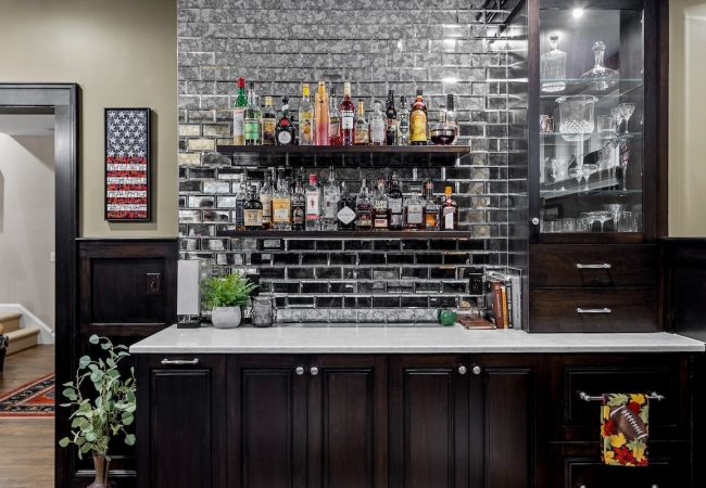Finished basement full bar with storage, built-in drawers, and shelving (JM Construction)