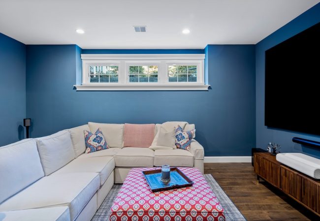 Finished basement family room with open floor plan and wall-mounted TV (JM Construction)