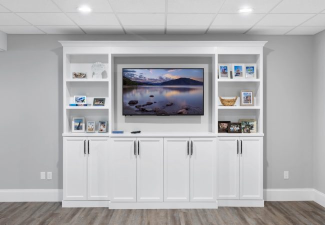 Finished basement with built-in cabinets, extra storage, and TV (JM Construction)