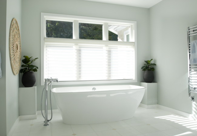 Updated bathroom with freestanding tub, large window, and updated tile (JM Construction)