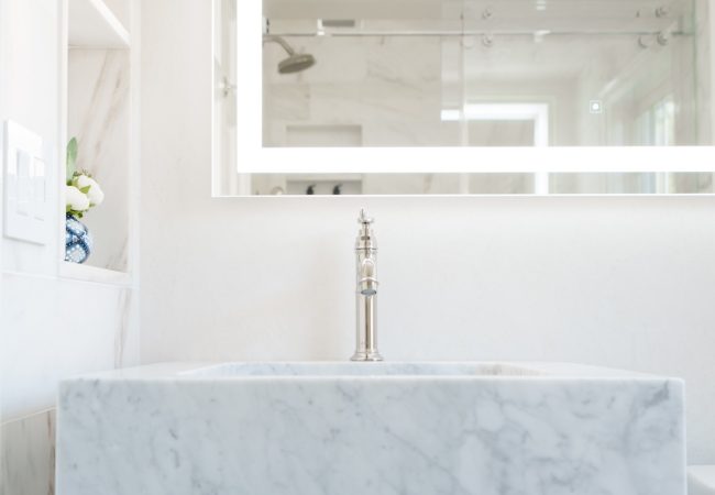 Large granite tub with oversized backdrop mirror (JM Construction)