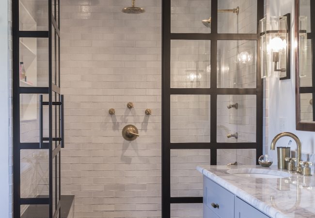 Updated bathroom with large walk-in dual-head shower and oversized vanity (JM Construction)