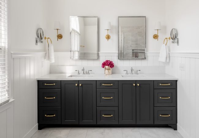 Updated bathroom with dual sinks, mirrors, and full vanity (JM Construction)