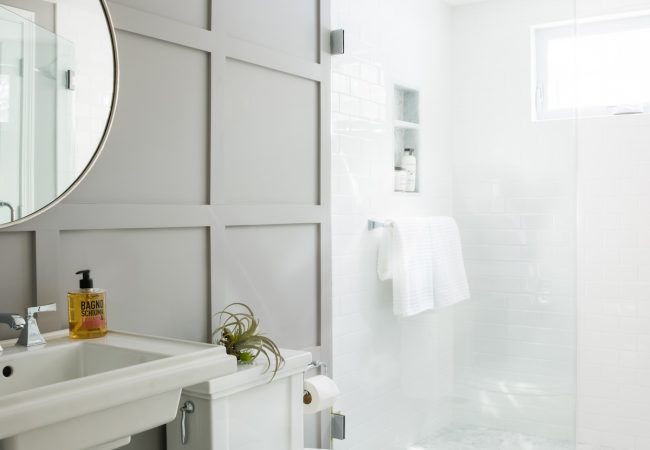 Updated bathroom with walk-in shower, toilet, and updated wall finishes (JM Construction)