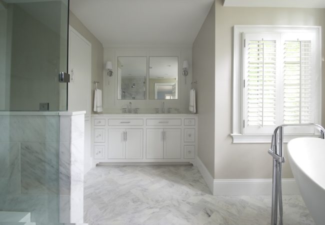 Updated bathroom with double vanity, walk-in shower, and freestanding tub (JM Construction)