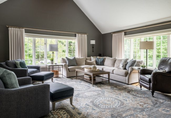 Spacious open floor plan living room with vaulted ceilings and large windows for natural light (JM Construction)