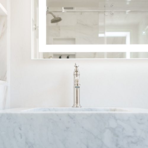Large granite tub with oversized backdrop mirror (JM Construction)