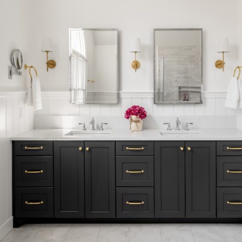 Updated bathroom with dual sinks, mirrors, and full vanity (JM Construction)